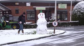 Man building a snowman at Riverside Meadows, Ripon during a break from Storm Larisa