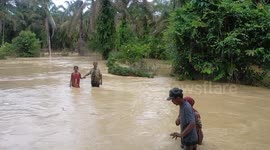 Indonesian residents forced to seek elevated shelter as river overflows causing flood