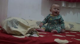 8 month old baby laughing and screaming while playing with Mr. Padang, West Sumatra