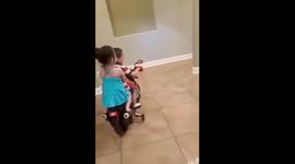 3 years old big brother riding a motorcycle with his little sister as passenger.