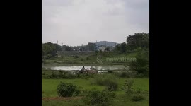 tractor plowing on green paddy field land, farmer on tractor work plowing agriculture in Odisha