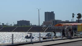 People enjoying a spring day on paddle board boats in downtown Corpus Christi Texas