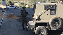 Israeli soldiers stand guard near West Bank's Nablus following shooting of three Palestinians