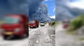 Sand-mining trucks scatter to avoid ash raining down after eruption of Indonesia's Mt Merapi
