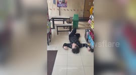 Drunk tourist sprawled on shop floor in Manila, Philippines