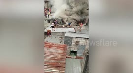 Locals battle fire in wooden homes that killed two children in the Philippines