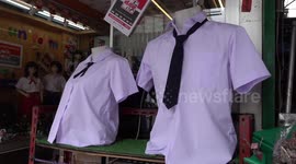 Young female Chinese tourists are buying Thai schoolgirl uniforms