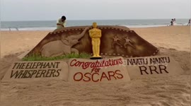 Indian Artist creates beautiful sand sculpture to congratulate indian movies winning oscar trophy