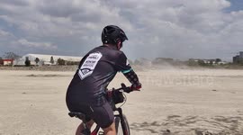 Brave cyclists ride through dust devil tornado ripping through bike track