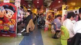 An Irishman wandering around Tokyo, enters an entertainment venue, which also appears to have gambling machines.