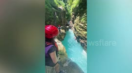 Tourist's leap into blue lagoon goes wrong when she slips on rocks