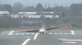 EXTENDED VIDEO - Terrifying moment plane is bounced around by gale force winds at Birmingham Airport