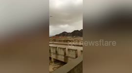 Flood rages under bridge as thunderstorms batter Saudi Arabia