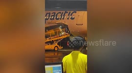 Baggage handlers caught on camera carelessly hurling suitcases into plane's hold