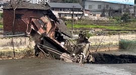 Terrifying moment massive sinkhole engulfs fish pond causing house collapse in southern China