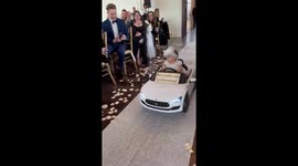 9-month-old flower girl drives down wedding aisle on remote control baby Maserati