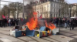Protesters set trash cans on fire during protest in Nantes, France