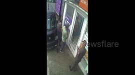 The robber shoots the atm money filling officer, the robber is caught by the police