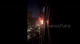 Woman's miraculous escape as she climbs out 14th-floor window to escape fire in China
