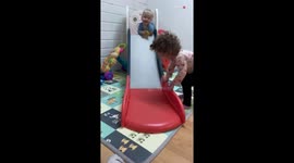 Excited boy experiences a 'slide' mishap after his head meets sister's knee