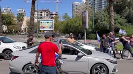 Bargy between a driver and protesters blocking the road in Tel Aviv, Israel