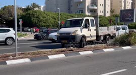 Cars go around protest blocking the road in Tel Aviv, Israel