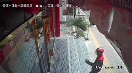 Terrifying moment gunman disguised as postman holds up gold shop before fleeing empty-handed