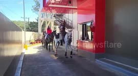 Drive-through customers order takeaway food on horseback
