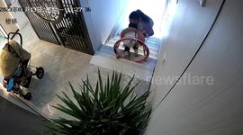 Quick-thinking female employee saves baby from falling down stairs in Chinese shop