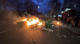 People set dumpsters on fire as massive protests against the retirement bill in France, take place, Paris, France