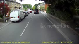 Child hangs out of a Landrover Discovery window trying to touch things as they pass roadworks. Obviously no seat belt
