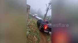 Pickup truck slides down steep slope and into parking spot
