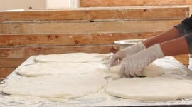 Palestinian men make samosa dough during ahead the Muslim holy month of Ramadan
