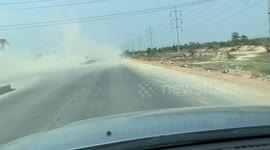 Smoke-belching tractor covers road in thick plumes of gas in Cambodia