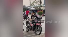 Funny pet Beagle sits on motorcycle like human while waiting for owner