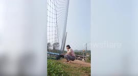 Kind teacher releases frightened stray dog stuck in football pitch net