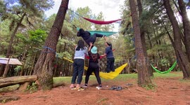 Girls learn that getting off a hammock can be as complicated as getting in one