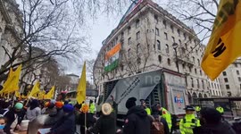 Officials at London's Indian High Commission provoke Sikh protesters below in a stand-off over flags