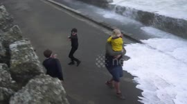 Locals dodge waves crashing over seawall as flood warning issued in Newquay