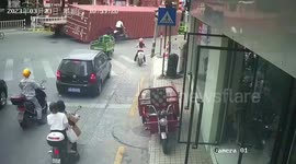 Container narrowly misses 3-wheeler rider after falling off cargo truck in China