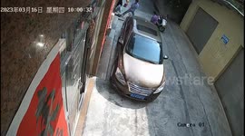 Woman gets accidentally stuck by roller shutter door, rescued by neighbors, passersby