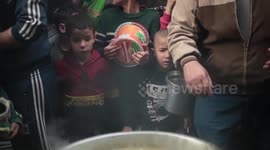 Palestinians gather to get a free soup during the holy month of Ramadan in the Al Shejaeiya neighbourhood Gaza