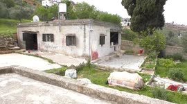 Palestinians inspect damage in a house, allegedly set on fire by Israeli settlers in the village of Sinjil north of the West Bank city of Ramallah