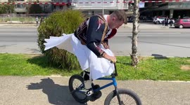 BMX rider catches the eye while performing bike tricks in folklore costume