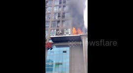 Women rescued after climbing out of burning high-rise building in southern China