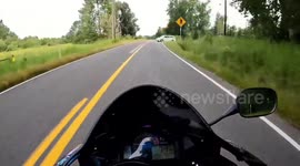 Close Call: Motorcyclist Narrowly Avoids Collision With a White Minivan