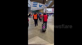 Strikers play The train goes nowhere song at the station in Munich, Germany