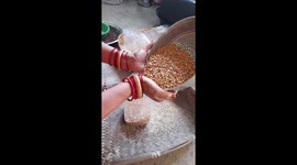 Indian woman chna dal storage at home with plastic bottle in India