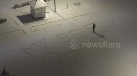 People draw words on the snow that covered St Petersburg again after total melt, Russia