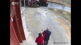 Elderly couple shocked after witnessing several trucks slide across slippery road in China